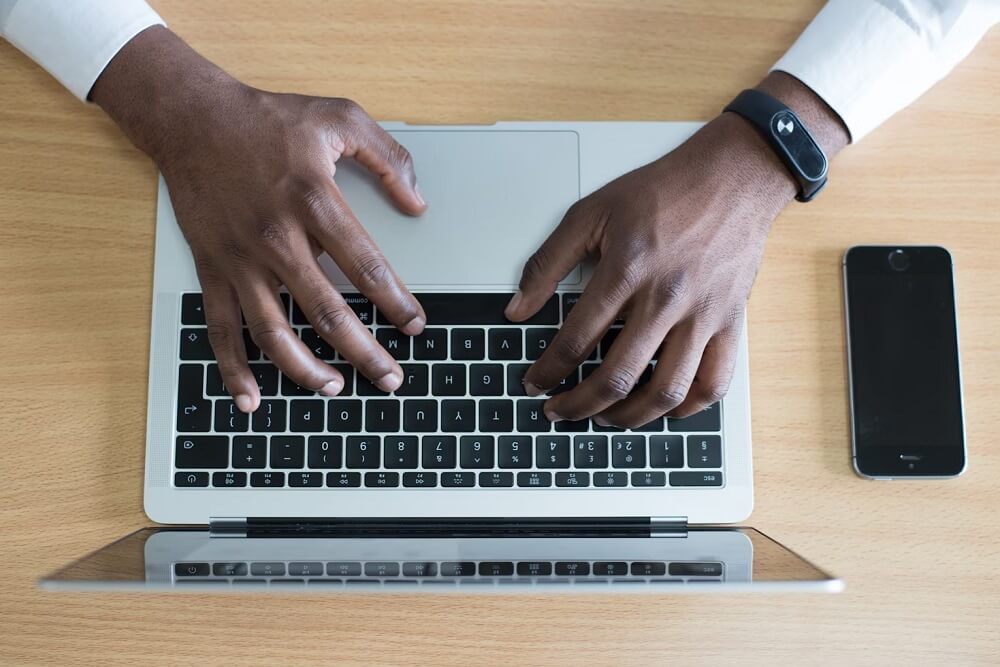 A person typing on Laptop
