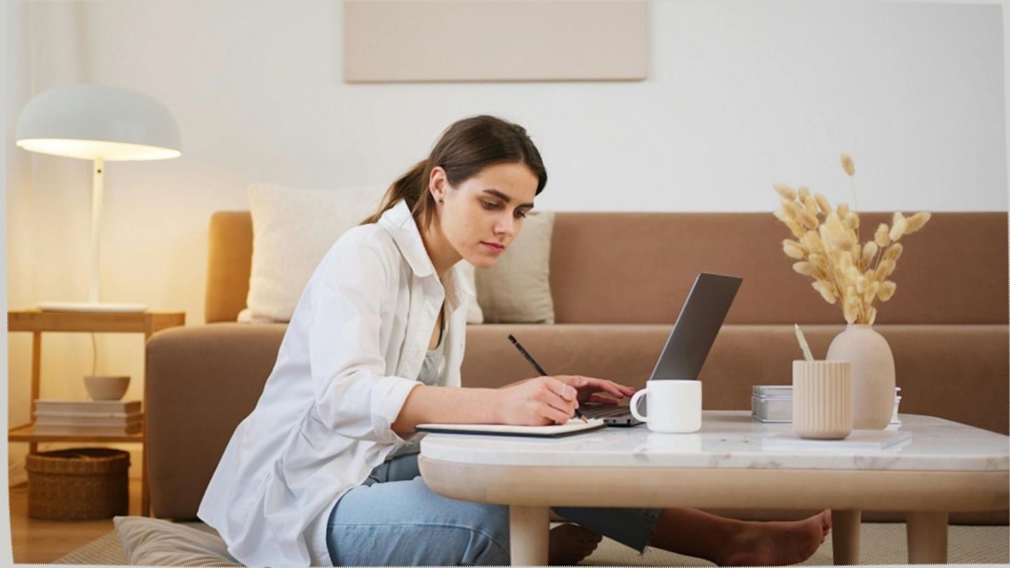 A girl writing and reading in the table